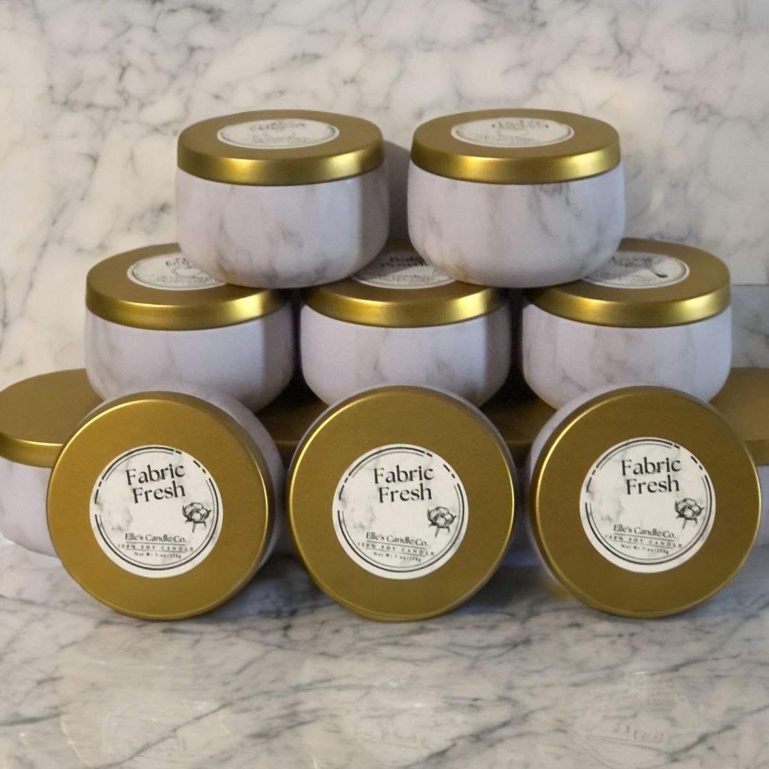 Fabric Fresh soy candle in a clear glass jar, scented with clean cotton and linen, photographed on a minimal surface.