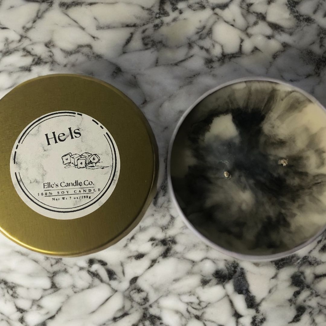 He Is soy candle in a frosted jar, with a clean, masculine scent blend, photographed against a modern neutral background.