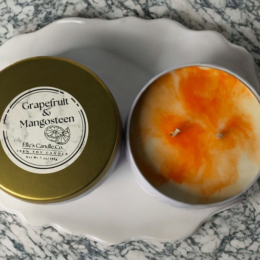 Grapefruit & Mangosteen soy candle in a glass jar, with citrus notes of grapefruit and tropical fruit, styled on a light surface.